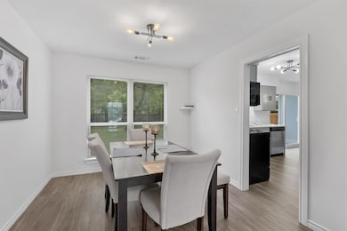 Dining space featuring a chandelier and light woo