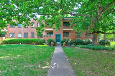 View of front of house featuring a front yard and brick siding