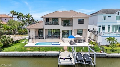 Back of house featuring a balcony, stucco siding,