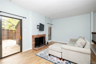 Hardwood floored living room featuring a fireplace