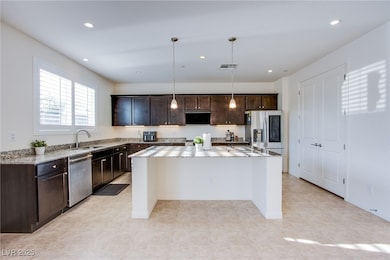 Kitchen featuring stainless steel appliances, a si
