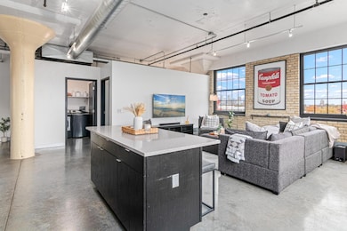 Urban living at its finest- concrete floors, brick walls and updated lighting.