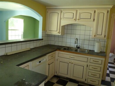 Kitchen featuring tasteful backsplash, dark tile f