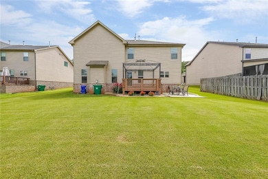 Rear view of house featuring a patio area and a de