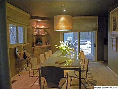 Dining room with columns at the large opening from
