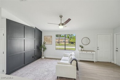 Living area with a ceiling fan, light wood-type fl