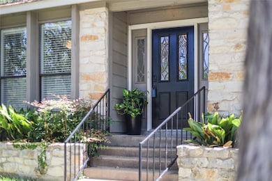 Property entrance with stone siding