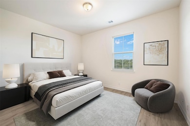 Bedroom featuring light wood-style flooring and b