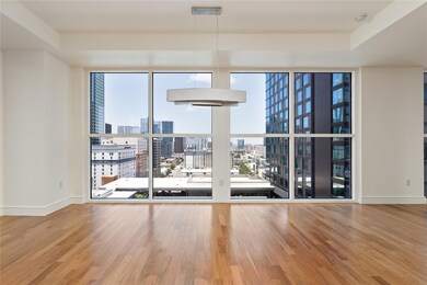 Spare room with a city view, wood finished floors