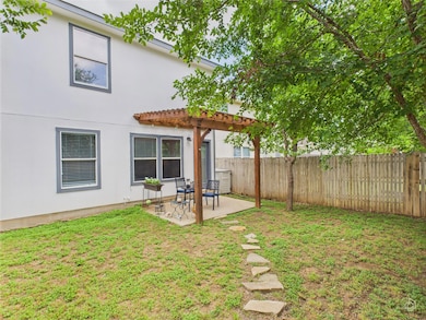 Fenced yard with a pergola and a patio