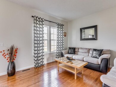 This lovely family room has hardwood floors throug