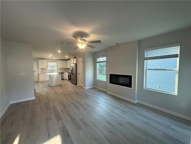 Unfurnished living room with visible vents, a glas