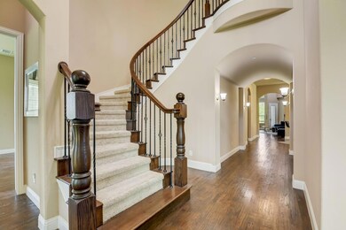 Foyer entrance with a high ceiling and dark hardwo