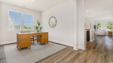 Home office with baseboards, dark wood-type flooring, and recessed lighting