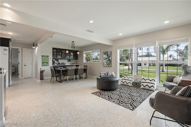 Living room featuring beamed ceiling and bar