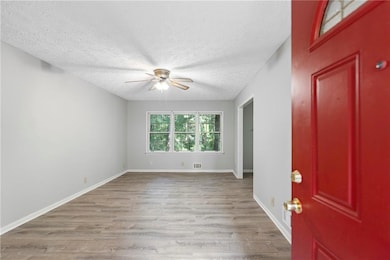 Foyer featuring wood finished floors, and a textured ceiling