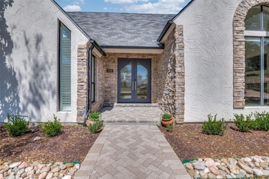 Doorway to property with french doors and stone si
