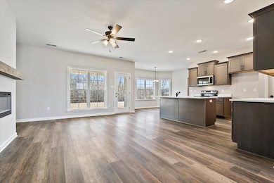 Kitchen with hanging light fixtures, a kitchen isl