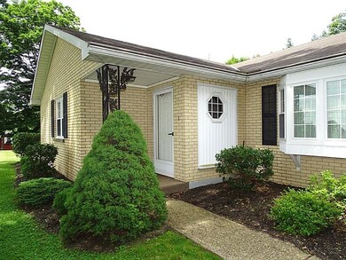 Level entry, covered front porch & attractive land