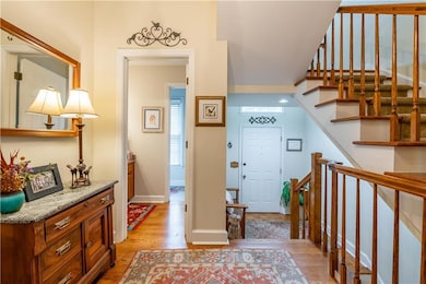 Foyer entrance with light wood-style floors and stairs