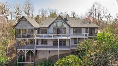 View of back of home with expansive decks, windows
