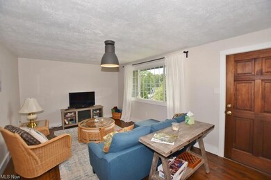 The living room open to a raised front deck with l