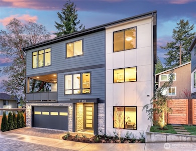 Striking twilight exterior showcases the modern architecture, covered outdoor living, and premium curb appeal of this final Houghton Collection home.
