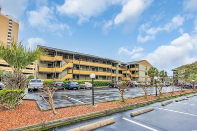 View of building exterior with uncovered parking