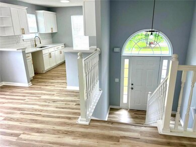 Foyer featuring light wood finished floors and baseboards