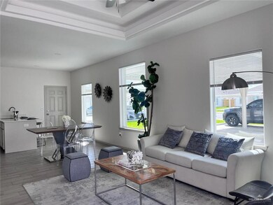 Living area with wood finished floors and ceiling fan