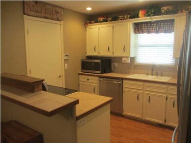 Tile-topped eating bar & wood laminate floor
