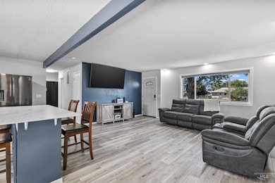 Living room with light wood-style floors and a textured ceiling
