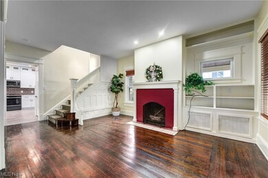 Wood burning fireplace in this foyer entrace with one of two stair cases to second floor & entry to new kitchen