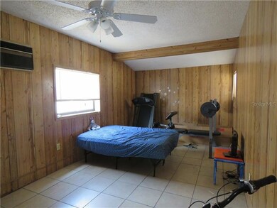 Master bedroom has tile floors, ceiling fan, close