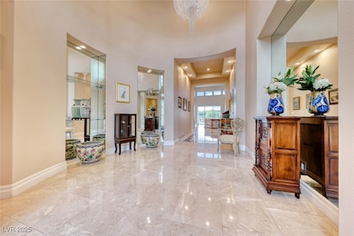 Entryway with marble finish floor, baseboards, and