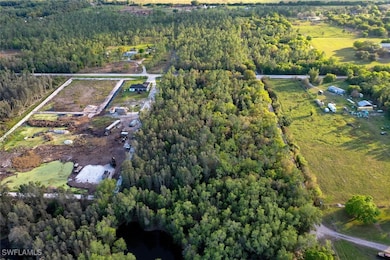 View of property location featuring a forest