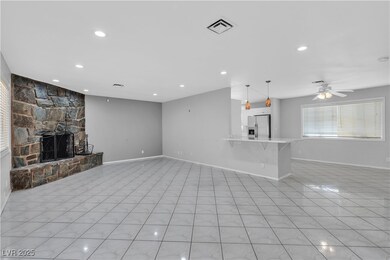 Unfurnished living room with visible vents, a fire