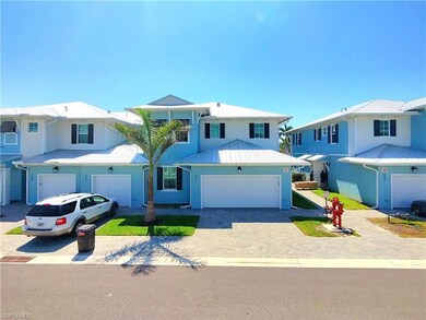 View of front of house with metal roof, a garage, 