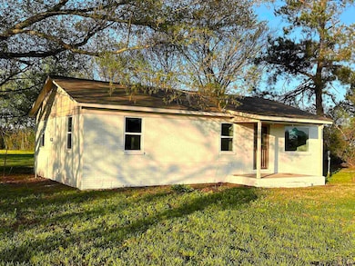 Rear view of property featuring a lawn