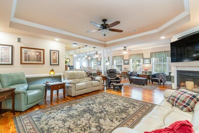 Living room featuring crown molding, wood-type flo