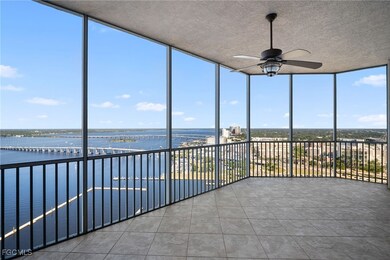 Unfurnished sunroom featuring floor to ceiling windows, a water view, tile patterned flooring, and a textured ceiling