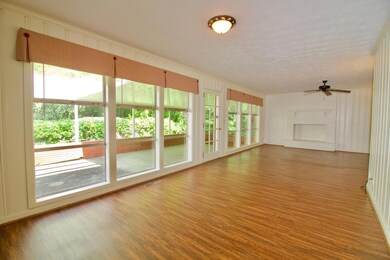Living/Dining room w/ wall to wall windows
