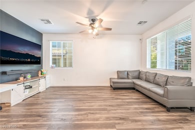 Living area featuring light wood-type flooring and ceiling fan