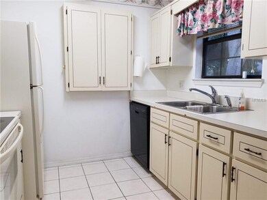 Brightly lit kitchen, with tile flooring and garba