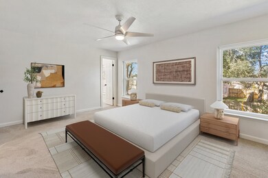 Bright and spacious primary bedroom featuring larg