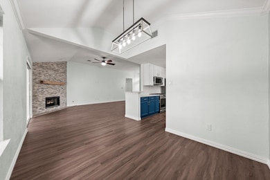 Unfurnished living room featuring ceiling fan, da
