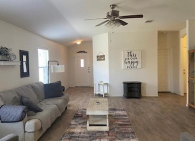 Living area featuring ceiling fan, wood finished 