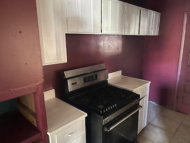 Kitchen featuring stainless steel range with gas s