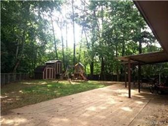 Beautiful lot with mature trees, fence and storage
