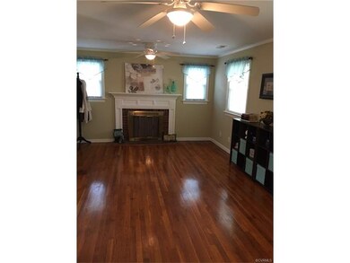 Family room w/ brick fireplace & hardwood floors